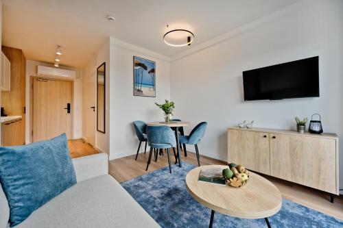 a living room with a couch and a table at Aparthotel Anchoria BlueApart in Mechelinki