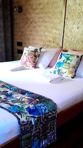 a bed with two pillows on top of it at At Home in Puerto Princesa City