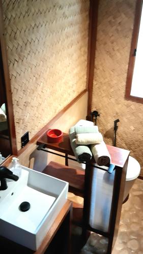 a bathroom with a sink and a toilet at At Home in Puerto Princesa City