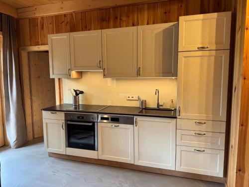 a kitchen with white cabinets and a stove top oven at Bio-Hof Lexmühle in Hammern