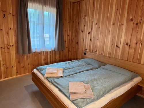 a bedroom with a bed with two towels on it at Bio-Hof Lexmühle in Hammern