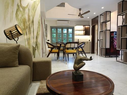 a living room with a couch and a table at Vidyarthy Villa in Kolkata