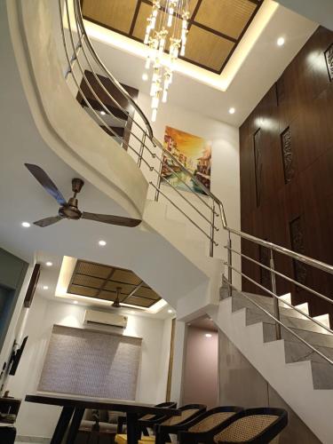 a spiral staircase in a house with chairs at Vidyarthy Villa in Kolkata