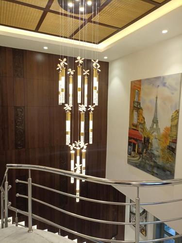 a chandelier hanging over a staircase in a building at Vidyarthy Villa in Kolkata
