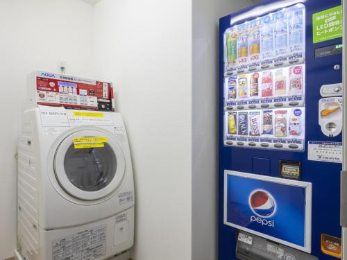a washing machine is next to a vending machine at ibis Styles Kyoto Shijo in Kyoto
