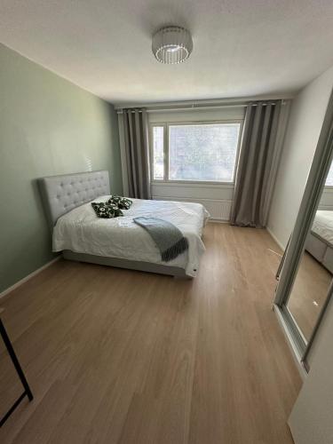 a bedroom with a bed and a large window at Apartment Korkalonkatu in Rovaniemi