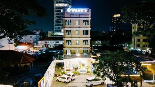 a building with a sign on top of it at night at Wangs Hotel Gurney Drive in George Town