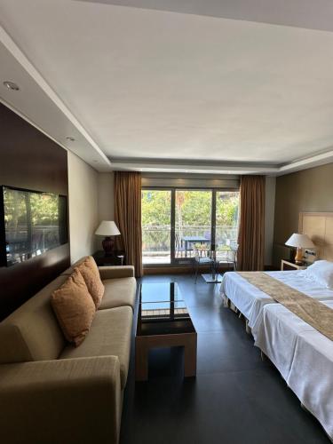 a hotel room with a bed and a couch at ArtPlatinum SUITES&APARTMENTS in Benalmádena