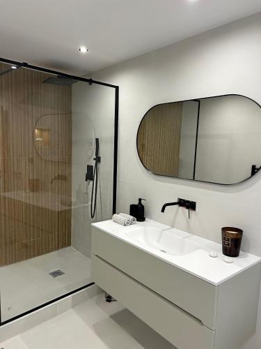 une salle de bain avec un lavabo blanc et une douche dans l'établissement Luxueux duplex au coeur du Vieil Antibes, à Antibes