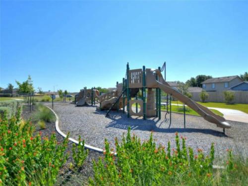 a playground with a slide in a park at Cozy Home Near Downtown Austin And Airport in Austin