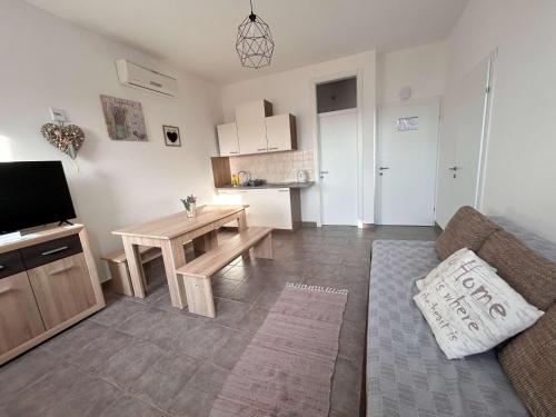 a living room with a couch and a table at DreamWorksApartments-1 in Karlobag