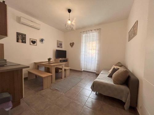 a living room with a couch and a table at DreamWorksApartments-1 in Karlobag