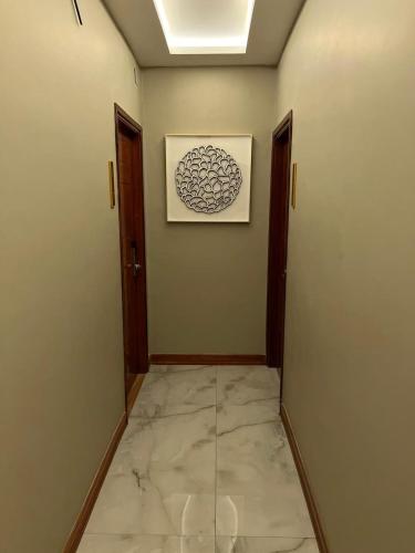 a hallway with two doors and a picture on the wall at Taj mahal residencial in Maputo