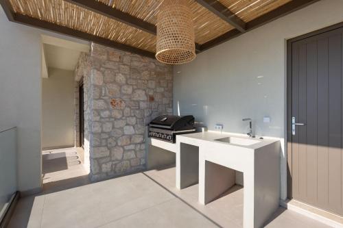 a kitchen with a sink and a stove at Villa Eptanisa in Sivota