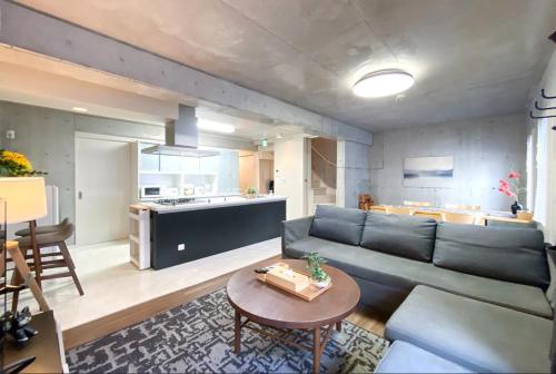 a living room with a couch and a table at Uhome Otsuka Villa in Tokyo