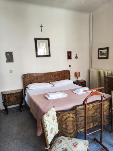 a bedroom with a bed with a cross on the wall at La Sartoria - Abitare la storia in Grottazzolina