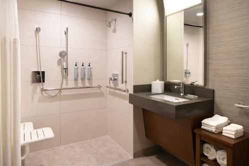 a bathroom with a sink and a shower at Courtyard San Francisco Airport Burlingame in Burlingame