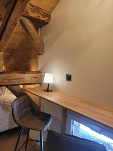 a desk in a room with a chair and a lamp at Chalet Lisa B&B in Morzine