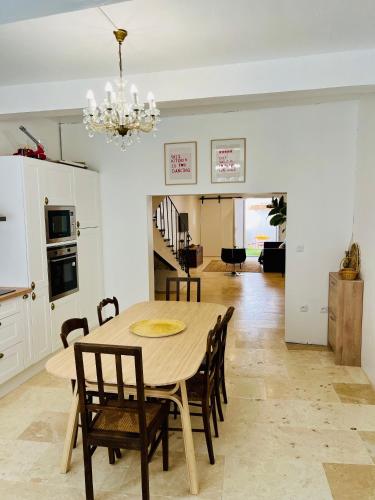 une cuisine et une salle à manger avec une table et des chaises dans l'établissement Maison de Village - Standing - Centre Historique, à Sigean