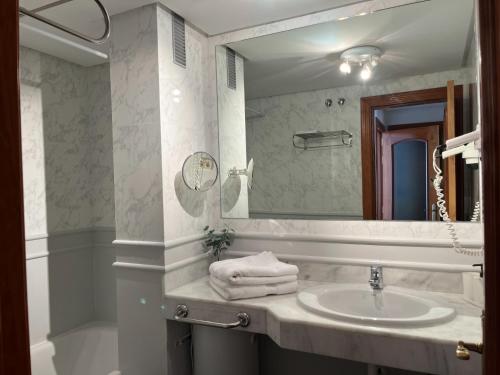 a bathroom with a sink and a large mirror at Ocean Dream Apartment in Playa Jandia