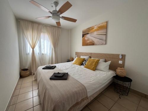 a bedroom with a large bed with a ceiling fan at Ocean Dream Apartment in Playa Jandia