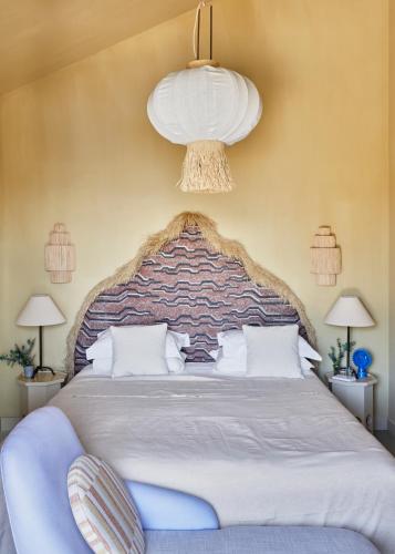a bedroom with a large bed and a chandelier at Pirate House Sea front Private Pool Garden Funchal in Funchal