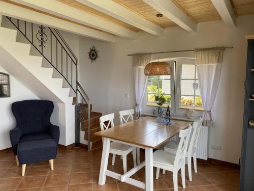 a dining room with a wooden table and chairs at Ferienhaus Seeperle in Sternberg