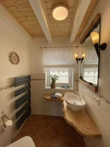 a bathroom with a white sink and a mirror at Ferienhaus Seeperle in Sternberg