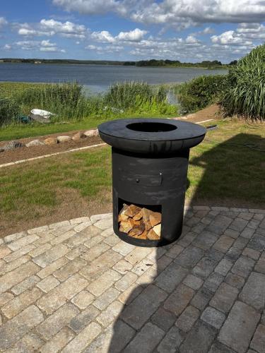 a black fire pit sitting on top of a patio at Ferienhaus Seeperle in Sternberg