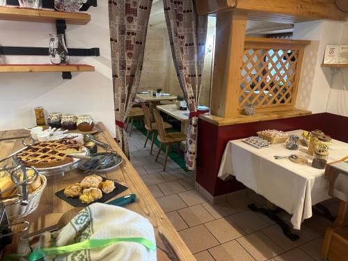 a restaurant with a table with food on it at Ski Lodge Pampeago in Tesero