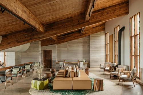 a lobby with a couch and chairs and tables at Ngorongoro Lodge member of Melia Collection - The Leading Hotels of the World in Ngorongoro