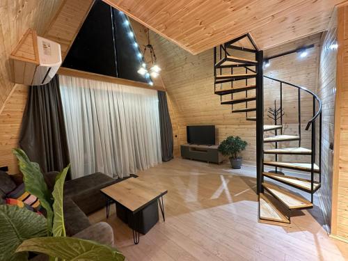 a living room with a spiral staircase in a house at Cottage Lemons In Gonio in Batumi