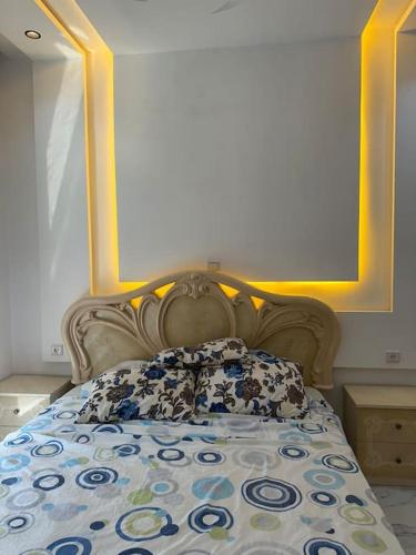 a bedroom with a large bed with a large picture on the wall at Villa superbe emplacement in Al Hoceïma