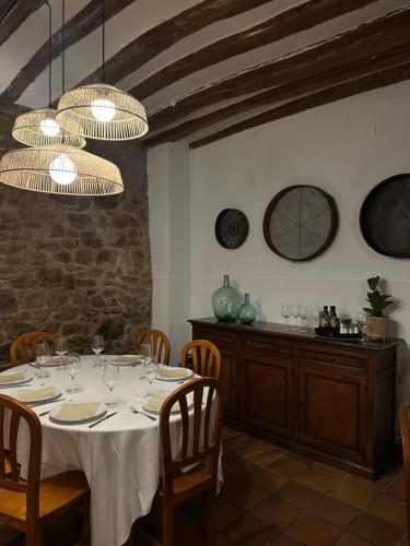 a dining room with a table and two chandeliers at Hotel - Restaurante La Posada de Santa Rita in Enciso