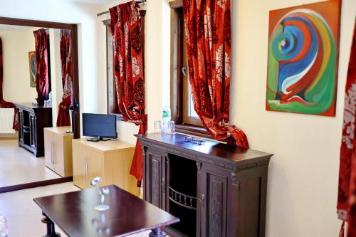 a living room with a fireplace and a painting on the wall at Хотел Свети Трифон in Melnik