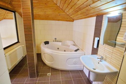 a bathroom with a tub and a sink at Хотел Свети Трифон in Melnik