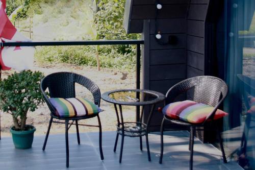 three chairs and a table on a patio at Cottage Lemons In Gonio in Batumi