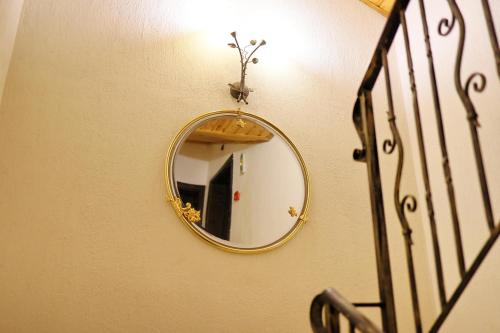 a mirror on a wall next to a staircase at Хотел Свети Трифон in Melnik