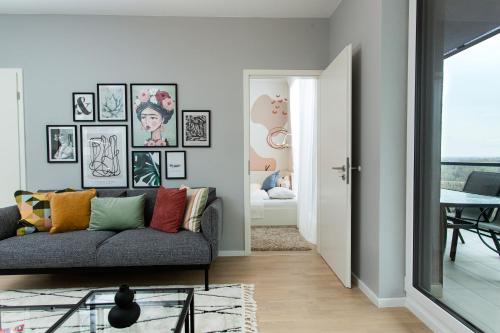 a living room with a couch and a table at Waterfront Residence Free Private Parking in Budapest