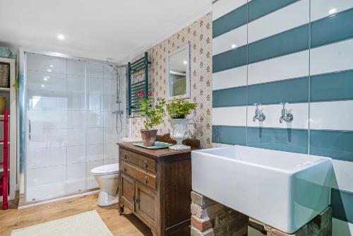 a bathroom with a tub and a sink and a toilet at Foxearth in Blandford Forum
