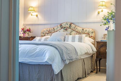 a bedroom with a bed with a floral headboard at Foxearth in Blandford Forum