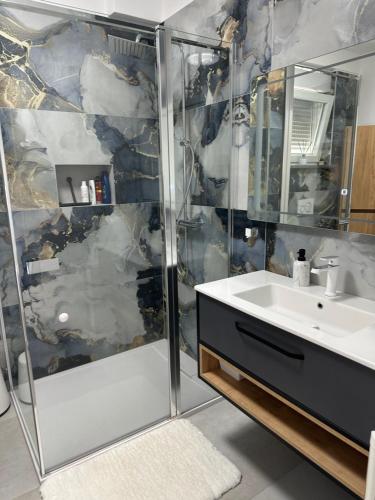 a bathroom with a shower and a sink at Apartments Roxsi in Novalja