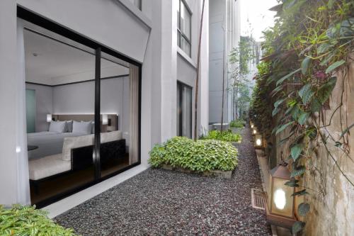 a bedroom with a bed in a building at Grand Aston Puncak Hotel & Resort in Puncak
