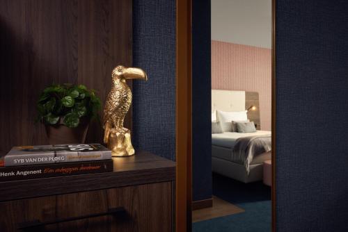 a statue of a bird on a dresser in a hotel room at Van der Valk Hotel Haarlem in Haarlem