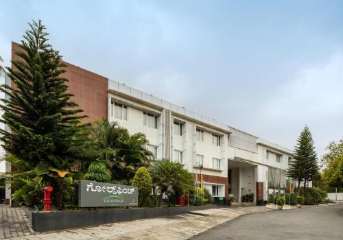 a building with a christmas tree in front of it at Goldfinch Retreat Bangalore in Devanahalli-Bangalore