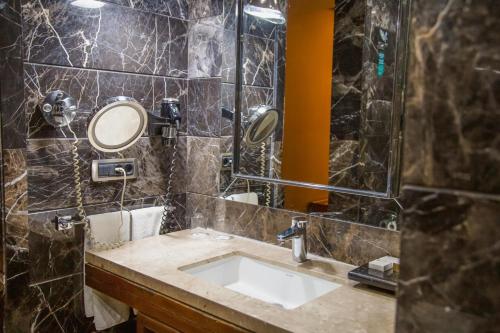 a bathroom with a sink and a mirror at Gold Majesty Hotel in Bursa