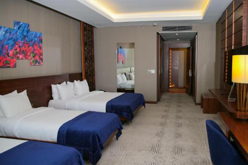 a hotel room with two beds and a television at Gold Majesty Hotel in Bursa