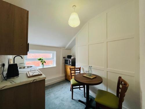 a kitchen with a table and a small table and chairs at The Briarcroft in Goole