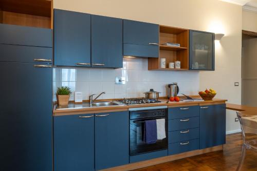 a kitchen with blue cabinets and a sink at Residence Ferraud in Pinerolo