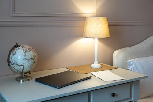 a table with a laptop and a globe on it at Residence Ferraud in Pinerolo